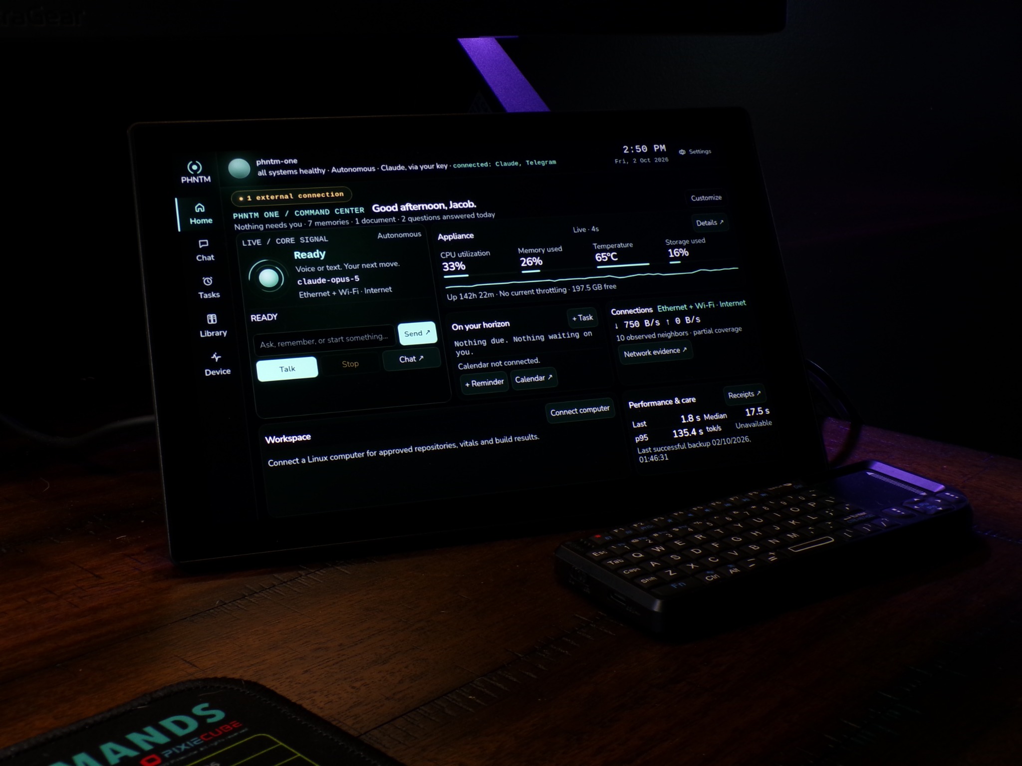 Real PHNTM One touchscreen and mini keyboard on a desk, displaying the updated Home screen