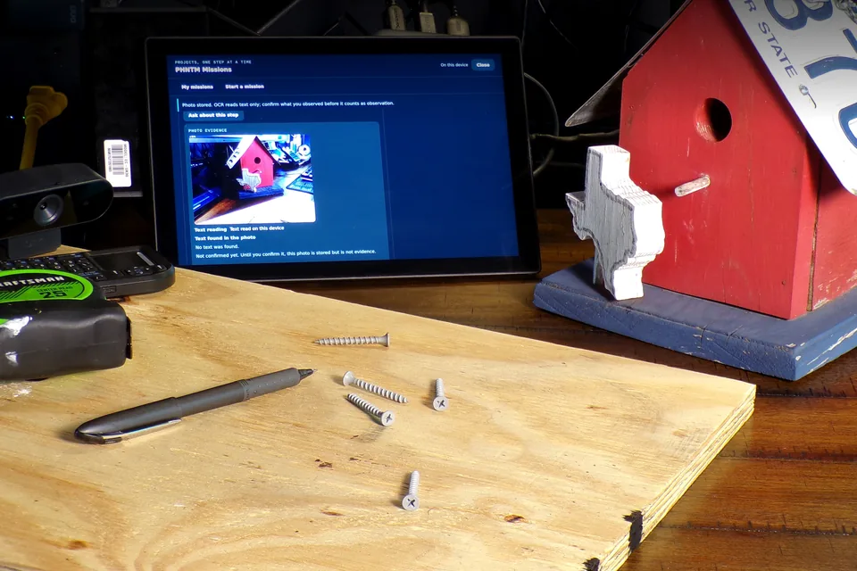 PHNTM One showing a Mission step with its stored webcam photo of a birdhouse, marked not confirmed yet, beside the webcam and the real birdhouse