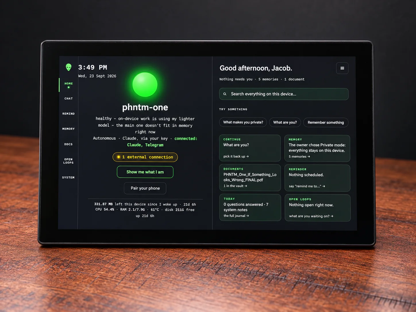 PHNTM One head-on, showing its home screen: greeting, search, memory, documents, reminders and open loops